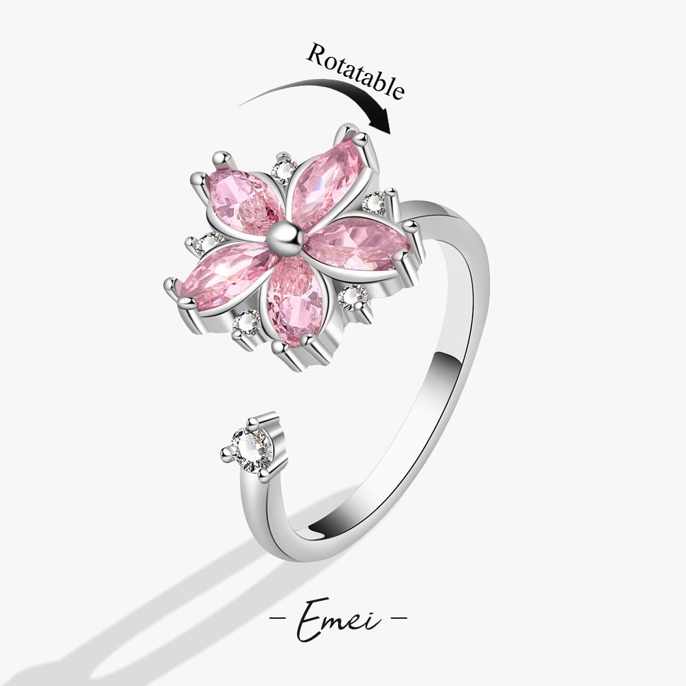 Floral zircon rotatable stress-relief ring.